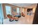 Comfortable living room with cozy seating, natural light, and an open layout to the kitchen at 2527 Terracina Dr, Venice, FL 34292