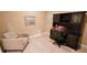 A tidy office space with a dark wood desk, rolling chair, and neutral colored walls at 2527 Terracina Dr, Venice, FL 34292