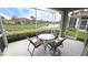 Relaxing screened patio with a view of the water and lush landscaping at 2527 Terracina Dr, Venice, FL 34292