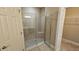 Modern tiled shower with glass door and built-in seat at 2527 Terracina Dr, Venice, FL 34292