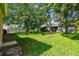 Lush backyard with mature trees and a well-maintained lawn for outdoor enjoyment at 2609 Rosehaven Dr, Wesley Chapel, FL 33544