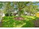 Expansive backyard showcases lush greenery, large trees, and shade at 2609 Rosehaven Dr, Wesley Chapel, FL 33544