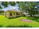 Spacious backyard with a sunny lawn and ample room for outdoor activities at 2609 Rosehaven Dr, Wesley Chapel, FL 33544