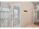 Bathroom featuring the glass enclosed shower, toilet area, and hallway at 2609 Rosehaven Dr, Wesley Chapel, FL 33544