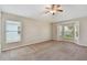 Bright bedroom featuring plush carpeting and large windows providing serene views at 2609 Rosehaven Dr, Wesley Chapel, FL 33544