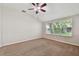 Bedroom with carpet flooring, ceiling fan, and window views at 2609 Rosehaven Dr, Wesley Chapel, FL 33544