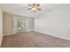 Spacious bedroom with bay windows, neutral carpet, and ample natural light at 2609 Rosehaven Dr, Wesley Chapel, FL 33544