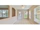 Dining area with neutral paint, tile floors, entry door and view of other living spaces at 2609 Rosehaven Dr, Wesley Chapel, FL 33544