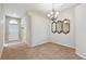Inviting dining room with elegant chandelier, decorative mirrors, and easy access to front entry at 2609 Rosehaven Dr, Wesley Chapel, FL 33544