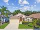 Charming home with manicured landscaping, stone accents, and attached garage at 2609 Rosehaven Dr, Wesley Chapel, FL 33544