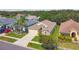 A beautiful aerial view of a single-story home with a manicured lawn and lovely landscaping at 2609 Rosehaven Dr, Wesley Chapel, FL 33544