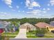Charming single-story home featuring a well-manicured lawn, a two car garage, and beautiful landscaping at 2609 Rosehaven Dr, Wesley Chapel, FL 33544