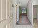 Inviting hallway showcasing neutral paint, tile flooring, and an open view to the living area at 2609 Rosehaven Dr, Wesley Chapel, FL 33544