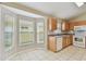 Bright kitchen with tile flooring, light wood cabinets and multiple windows offering lots of natural light at 2609 Rosehaven Dr, Wesley Chapel, FL 33544