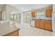 Open kitchen with wood cabinets, a breakfast bar, tile floors and views of other living spaces at 2609 Rosehaven Dr, Wesley Chapel, FL 33544