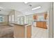 Modern kitchen with wood cabinets, a breakfast bar, tile floors and views of other living areas at 2609 Rosehaven Dr, Wesley Chapel, FL 33544