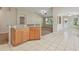 Open-concept kitchen with breakfast bar and tile flooring seamlessly connects to the living area at 2609 Rosehaven Dr, Wesley Chapel, FL 33544