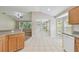 Bright kitchen with seamless flow to the living room, featuring tile floors and modern appliances at 2609 Rosehaven Dr, Wesley Chapel, FL 33544