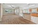 Open living room with natural light and access to the kitchen and other living spaces at 2609 Rosehaven Dr, Wesley Chapel, FL 33544