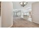 Spacious living room connects to the kitchen, featuring a ceiling fan and natural light at 2609 Rosehaven Dr, Wesley Chapel, FL 33544