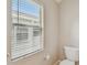 Toilet room featuring a toilet and window with blinds at 2609 Rosehaven Dr, Wesley Chapel, FL 33544