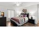 Comfortable bedroom with a queen bed, stylish lamps, and decorative accents creating a relaxing atmosphere at 2699 Pine Ridge E Way # H2, Palm Harbor, FL 34684