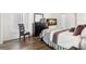 Cozy bedroom with wood floors, neutral-toned bedding, and bright windows offering ample natural light at 2699 Pine Ridge E Way # H2, Palm Harbor, FL 34684