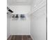 Organized walk-in closet with white wire shelving and ample storage space for clothes and accessories at 2699 Pine Ridge E Way # H2, Palm Harbor, FL 34684