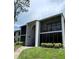 Condo exterior showcasing well-maintained landscaping and screened-in balconies for outdoor enjoyment at 2699 Pine Ridge E Way # H2, Palm Harbor, FL 34684