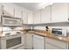 Bright kitchen with essential appliances at 2699 Pine Ridge E Way # H2, Palm Harbor, FL 34684