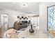 Open living space with dining area and living room, featuring stylish decor and abundant natural light at 2699 Pine Ridge E Way # H2, Palm Harbor, FL 34684