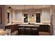 Modern kitchen featuring an island with seating, stylish pendant lighting, and marble countertops at 2719 13Th N St, St Petersburg, FL 33704