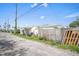 View of the backyard of the home and the surrounding greenery under a partly cloudy sky at 3108 56Th S St, Gulfport, FL 33707