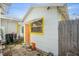 Exterior shows white siding, orange door with yellow trim, and a compact backyard area at 3108 56Th S St, Gulfport, FL 33707