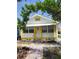 Charming home with a white exterior, bright yellow trim, and a quaint front porch at 3108 56Th S St, Gulfport, FL 33707