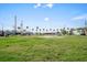 Expansive, grassy vacant lot with palm trees lining the waterfront under a sunny sky at 3108 56Th S St, Gulfport, FL 33707