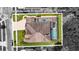 Overhead shot of home with paved driveway, screened pool, and neat landscaping in Wesley Chapel, FL at 3148 Watermark Dr, Wesley Chapel, FL 33544