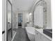 Elegant bathroom showcasing a large soaking tub, marble accents, and seamless glass shower at 3148 Watermark Dr, Wesley Chapel, FL 33544