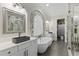 This luxurious bathroom features dual vanities, soaking tub, and elegant marble accents at 3148 Watermark Dr, Wesley Chapel, FL 33544