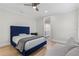 Bright bedroom features light walls, wood floor, and an ensuite bathroom at 3148 Watermark Dr, Wesley Chapel, FL 33544
