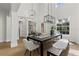Elegant dining room with modern lighting, a large dining table, and views into adjacent living spaces at 3148 Watermark Dr, Wesley Chapel, FL 33544
