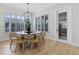 Bright dining area featuring a round table with shuttered windows and wood flooring at 3148 Watermark Dr, Wesley Chapel, FL 33544