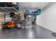 Well-organized garage space with overhead storage racks and ample room for vehicles and equipment at 3148 Watermark Dr, Wesley Chapel, FL 33544
