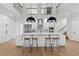 Open concept kitchen with white cabinets, stainless steel appliances, a large island, and counter seating at 3148 Watermark Dr, Wesley Chapel, FL 33544
