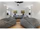 Cozy entertainment room with a large sectional sofa, bean bag chairs, and accent lighting at 3148 Watermark Dr, Wesley Chapel, FL 33544