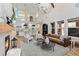Open-concept living room with fireplace, high ceilings, and views into the kitchen at 3148 Watermark Dr, Wesley Chapel, FL 33544