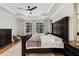 Inviting main bedroom with hardwood floors, dark wood furniture, and large windows overlooking the pool at 3148 Watermark Dr, Wesley Chapel, FL 33544
