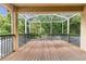 Enclosed back patio with a wood floor overlooking green outdoor space at 3148 Watermark Dr, Wesley Chapel, FL 33544