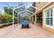 Paver-covered, enclosed patio features a ping pong table and outdoor bar at 3148 Watermark Dr, Wesley Chapel, FL 33544