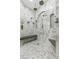 Luxury shower featuring double shower heads, marble accents, and built in bench seating at 3148 Watermark Dr, Wesley Chapel, FL 33544